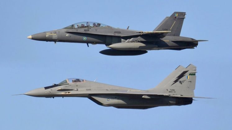Royal Malaysian Air Force F-18D (top) and MiG-29