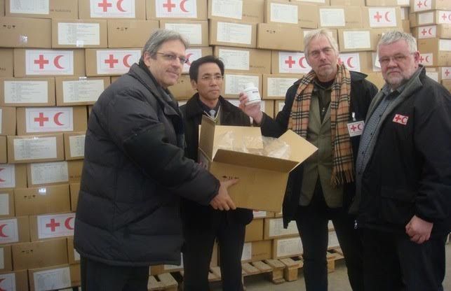 Felix Abt and O Son Gun, his North Korean deputy CEO, handing the first large order of pharmaceutical kits, containing antibiotics and painkillers for adults and kids, won in a competition against pharmaceutical manufacturers in Asia and Europe, to representatives of the IFRC (Intl. Federation of Red Cross and Red Crescent Societies).