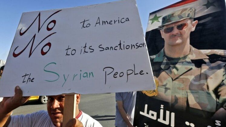 Syrian Man Protesting Against the U.S.-Led Sanctions Regime