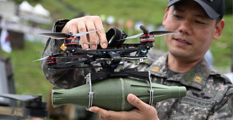 A South Korean Serviceman Holding a Drone with a Mock Bomb