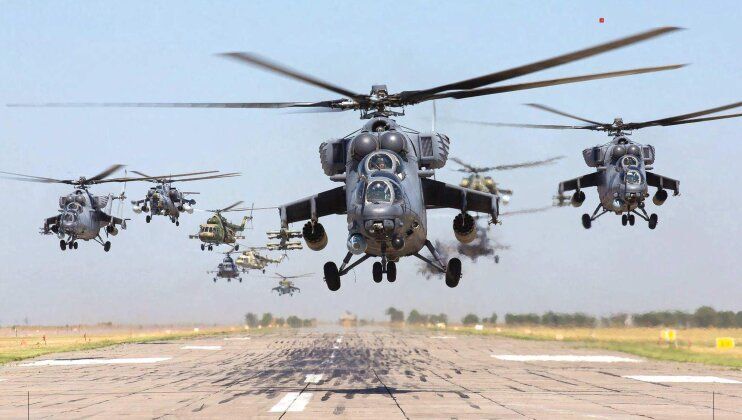 Three Mi-35s Lead Assortment of Helicopter Types in Flight